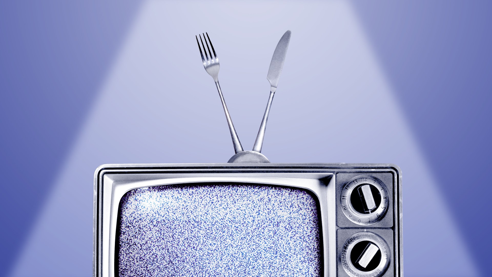 An old TV with a fuzzy screen and an antenna made from a fork and knife.