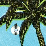 A palm tree with an ornament made out of a CD hiding in the leaves