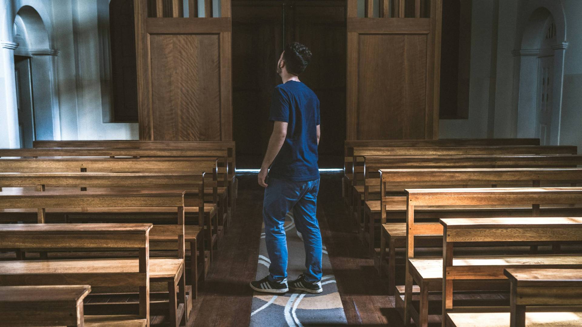 man standing in empty church