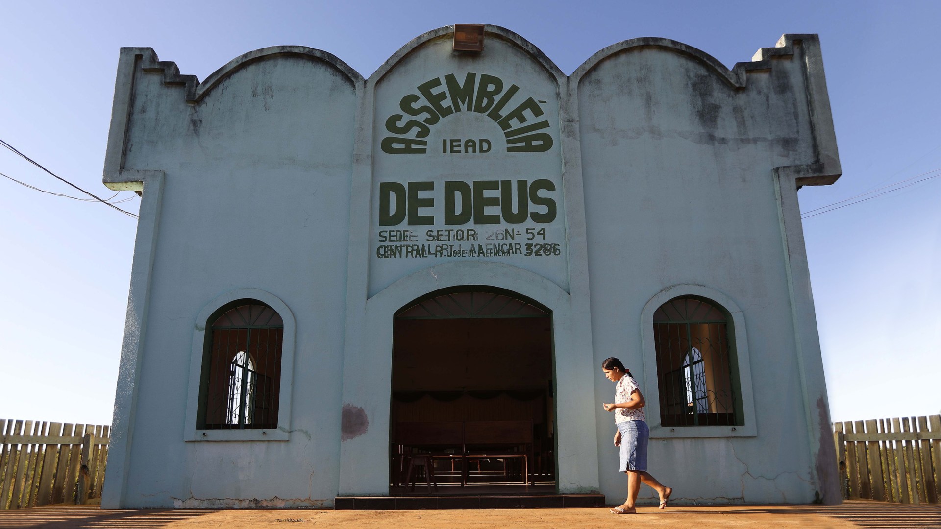 A woman walks before Sunday services at an evangelical church located in a partially deforested section of the Amazon rainforest in Brazil. 