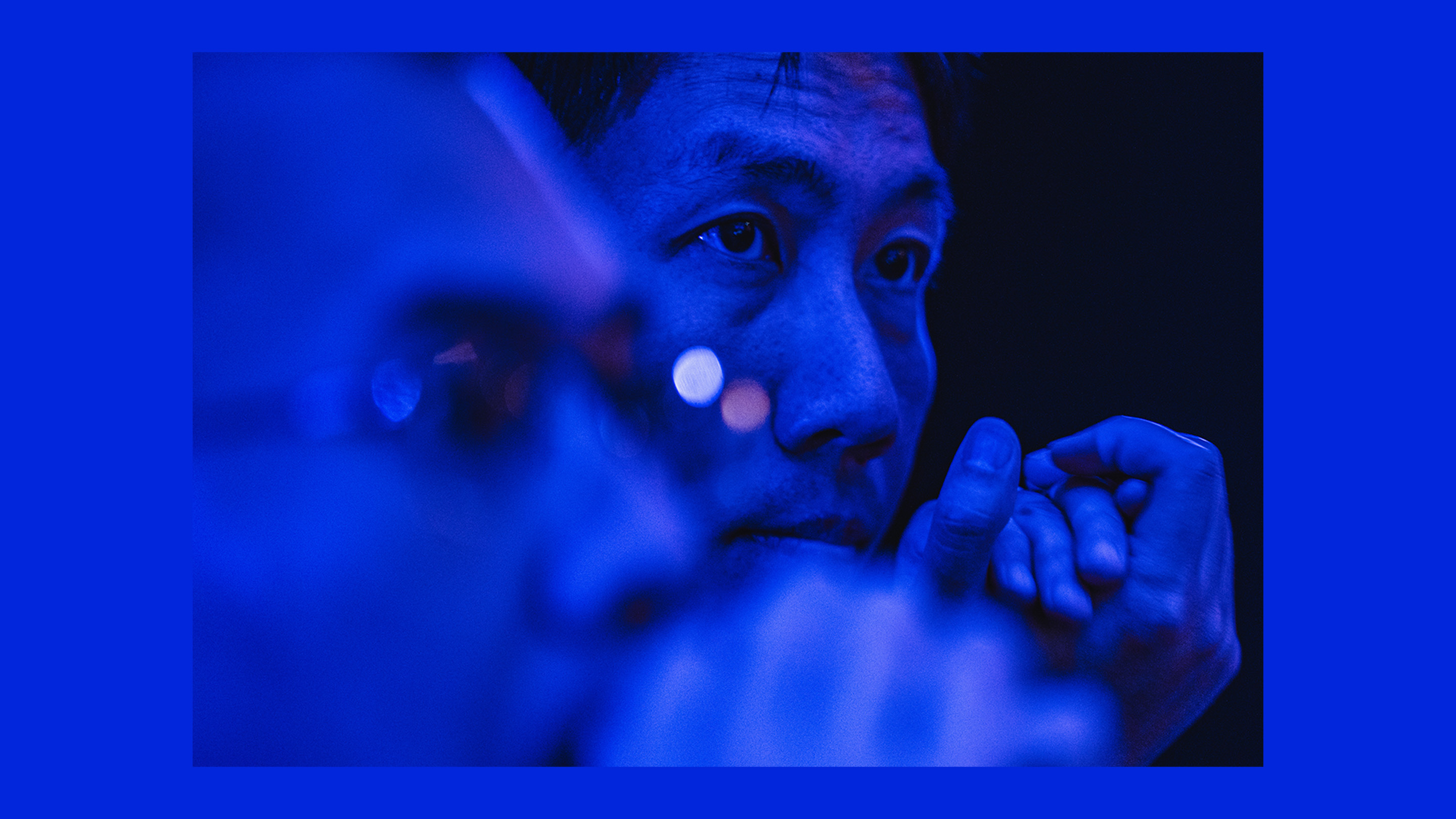 A photo of a tech engineer with blue lighting