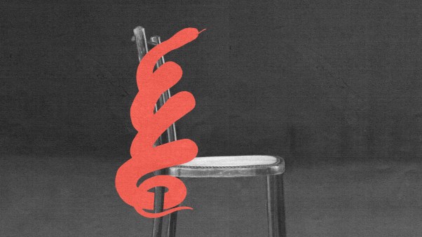 A red snake coiled around an empty chair