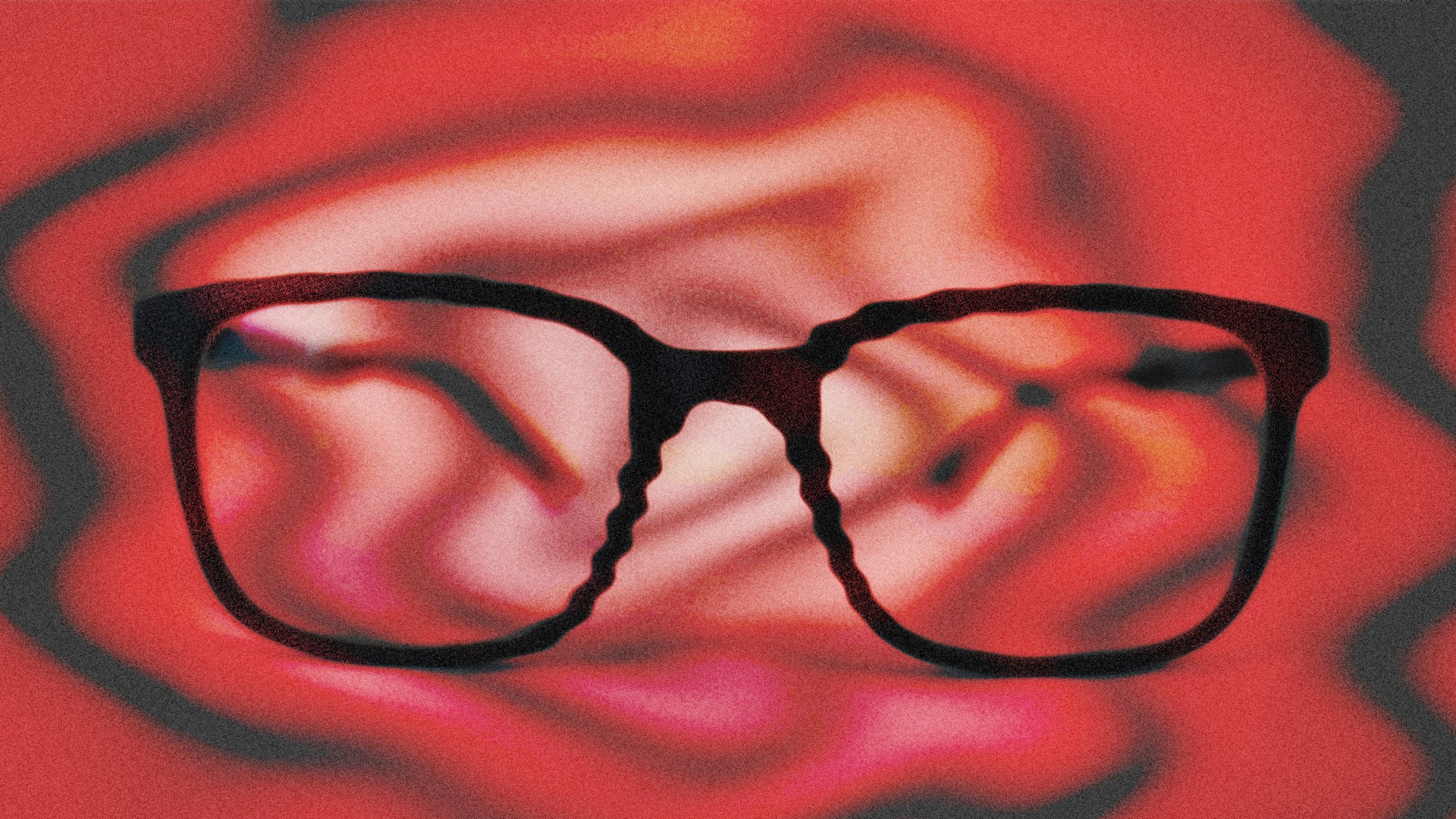 A fuzzy distorted image of glasses on a red background.
