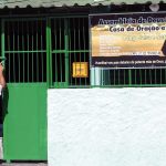 Man paints a gate of an Assemblies of God church in Brazil
