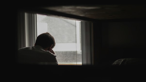 A man sitting by a window.